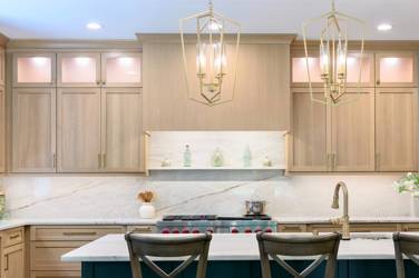 White oak kitchen with sage green island and white quartzite waterfall counters in Raleigh, NC