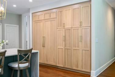 White oak kitchen with sage green island and white quartzite waterfall counters in Raleigh, NC