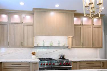 White oak kitchen with sage green island and white quartzite waterfall counters in Raleigh, NC