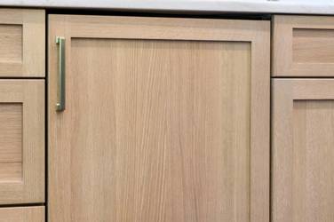 White oak kitchen with sage green island and white quartzite waterfall counters in Raleigh, NC