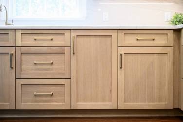 White oak kitchen with sage green island and white quartzite waterfall counters in Raleigh, NC