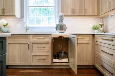 White oak kitchen with sage green island and white quartzite waterfall counters in Raleigh, NC