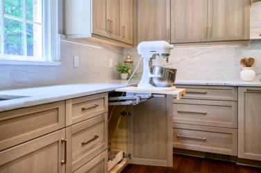 White oak kitchen with sage green island and white quartzite waterfall counters in Raleigh, NC