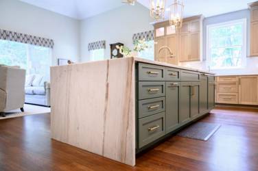 White oak kitchen with sage green island and white quartzite waterfall counters in Raleigh, NC