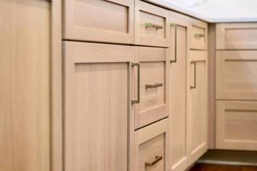 White oak kitchen with sage green island and white quartzite waterfall counters in Raleigh, NC