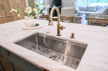 White oak kitchen with sage green island and white quartzite waterfall counters in Raleigh, NC