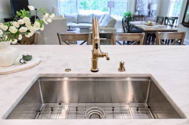 White oak kitchen with sage green island and white quartzite waterfall counters in Raleigh, NC