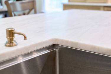 White oak kitchen with sage green island and white quartzite waterfall counters in Raleigh, NC