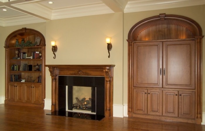 Design your family room to have built-in bookshelves, hide-away TV, and a matching custom Fireplace Surround Mantel