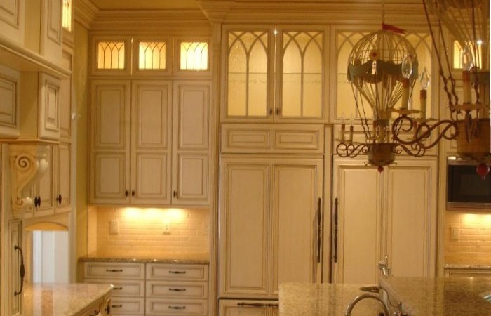 Add in-cabinet and under-cabinet lighting and glass doors to customize your kitchen design by Carolina Cabinet Specialist